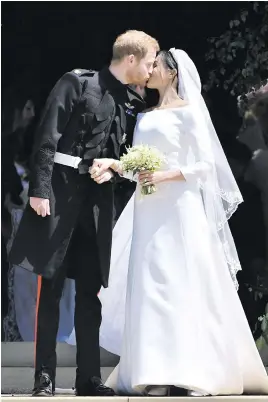  ?? Picture: Ben Stansall/AFP ?? SEALED WITH A KISS. Prince Harry, Duke of Sussex, kisses his wife Meghan, Duchess of Sussex, as they leave St George’s Chapel in Windsor, on May 19, after their wedding.