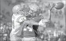  ?? Ralph Freso Associated Press ?? THEO HOWARD of UCLA tries to reach a pass from Speight in the second half, but cornerback Chase Lucas of Arizona State gets in the way.