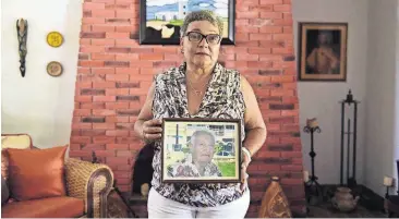  ?? [AP PHOTO] ?? Nerybelle Perez holds a portrait of her father, Efrain Perez, who died inside an ambulance after being turned away from the largest public hospital when it had no electricit­y or water, days after Hurricane Maria passed, in Guaynabo, Puerto Rico.