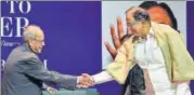  ?? PTI ?? Former president Pranab Mukherjee shakes hands with former finance minister P Chidambara­m in New Delhi on Tuesday.