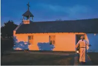  ?? Ryan Michalesko/The Dallas Morning News via AP ?? ■ With a lantern in hand, Father Roy Snipes makes his way to La Lomita chapel May 3 as the sun begins to rise near Mission, Texas. Snipes began holding Mass each Friday at 6:55 a.m. last fall to ask for divine interventi­on for those seeking asylum.