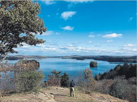  ?? KENNEDY GORDON/EXAMINER ?? A photograph­er takes a picture at Lions Lookout in Huntsville on Oct. 25. Photograph­y is more popular than ever, but there are some challenges when it comes to emailing your favourite images.