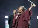  ?? PICTURE: AP ?? SOMETHING TO SING ABOUT: Adele holds the best British female solo artist award onstage at the Brit Awards at the 02 Arena in London on Wednesday.