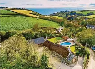  ??  ?? The thatched property in Cornwall’s Helston has an asking price of £1.1 million.