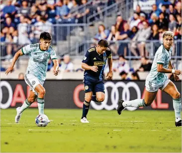  ?? DAKOTA WILLIAMS/ATLANTA UNITED ?? Atlanta United midfielder Thiago Almada (left) says the team needs to try to win every game from this point, but he feels the club isn’t down for the count yet when it comes to the playoffs.