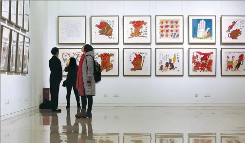  ?? PHOTOS BY JIANG DONG / CHINA DAILY ?? An ongoing exhibition by artist Huang Yongyu at Beijing’s National Museum of China features 168 pieces about Chinese zodiac animals.
