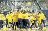  ?? GREGORY SHAMUS / Getty Images ?? Michigan players celebrate their Big Ten championsh­ip Thursday night after defeating Michigan State 69-50 at Crisler Arena in Ann Arbor, Mich.