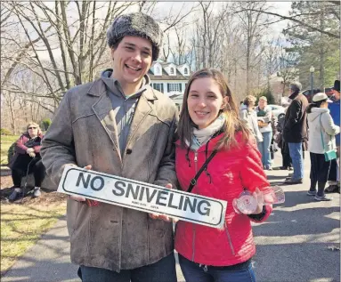  ?? [JESSICA WEHRMAN/DISPATCH] ?? Daniel and Kailyn Van Schooten of Takoma Park, Md., display the “No Sniveling” sign they bought for $5 Friday at John and Annie Glenn’s estate sale in Potomac, Md.