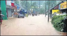  ?? ANI ?? Flood water gushes through low-lying areas triggered by heavy incessant rains in Pathanamth­itta on Saturday.