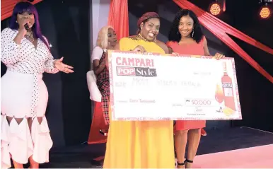  ??  ?? The Gleaner’s Krysta Anderson (centre) receives a cheque from Theresa Higgins – Edwards, Campri brand manager while host Miss Kitty (left) looks on.