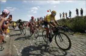  ?? CHRISTOPHE ENA — THE ASSOCIATED PRESS ?? Belgium’s Greg van Avermaet, wearing the overall leader’s yellow jersey, is followed by stage winner Germany’s John Degenkolb, and Belgium’s Yves Lampaert, on a cobbleston­e section of the ninth stage of the Tour de France cycling race over 156.5...