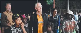  ??  ?? FIRST HAND: Prime Minister Malcolm Turnbull meets local kids as he rides along in a Julalikari Youth Night Patrol convoy at Tennant Creek.