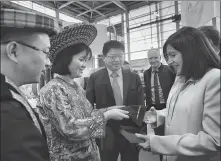  ?? PHOTOS PROVIDED TO CHINA DAILY ?? Clockwise from top: Huayao craftswome­n make intricate cross-stitch patterns in Baishuidon­g village, Longhui county in Shaoyang, Hunan province; Huayao cross-stitch works are shown to Paris Mayor Anne Hidalgo (right) at the China pavilion during the 2019 Foire de Paris; cultural and creative products with designs based on cross-stitch works, including ties.