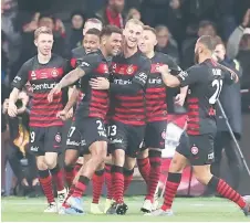  ??  ?? The Western Sydney Wanderers players celebrate a goal in the Australia’s ALeague match in this file photo.