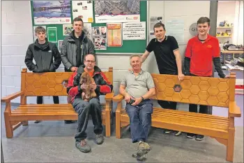  ??  ?? Teacher Steve Garraway and some of the Arran High pupils who designed and created the memorial benches for Graham Chappell, who is seated on the left with Dusty the Irish setter.