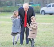 ??  ?? US President Donald Trump walks with his grandchild­ren Arabella and Joseph at the White House on Friday.