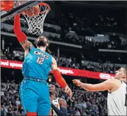  ?? ZALUBOWSKI] [AP PHOTO/DAVID ?? Oklahoma City Thunder center Steven Adams dunks as Denver Nuggets center Nikola Jokic watches during Tuesday night's NBA game in Denver.