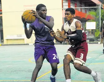  ??  ?? Kingston College’s Shevan Grant (left) goes up against Herbert Morrison’s Norton Brown in their ISSA All-Island U-19 Basketball play-off game. Herbert Morrison won 59-54.