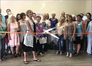  ?? Photo by Amber Dicken ?? A grand opening ribbon cutting ceremony was held last Wednesday night for Essentrics which drew a good crowd. Cindee Johnson, instructor, cuts the ribbon for her new space located at 701 McNelly Road, Bentonvill­e.