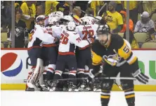  ?? Gregory Shamus / Getty Images ?? The Capitals celebrate after their 2-1 overtime win over Pittsburgh put them into the Eastern Conference finals.