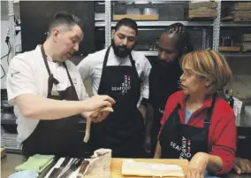  ?? ?? Mathallen Tromsø Head Chef and co-owner Gunnar Jensen (left) discusses superiorgr­ade clipfish with Jamaican Executive Culinary Artist Oji Jaja (second right) and Dominican Republic chefs Enmanuel Santos and Jacqueline Henriquez.