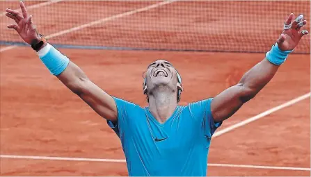  ?? MICHEL EULER THE ASSOCIATED PRESS ?? Spain’s Rafael Nadal celebrates winning the men’s final match of the French Open tennis tournament against Austria’s Dominic Thiem in three sets, 6-4, 6-3, 6-2, at the Roland Garros Stadium in Paris on Sunday. It was his 11th French Open title.