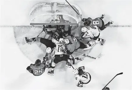  ??  ?? The USA and Canada crowd the goal cage area after a deflected shot during the second period. GEOFF BURKE/USA TODAY SPORTS