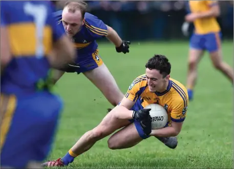  ??  ?? Beaufort’s Sean Kelleiher is challenged by Domhnall McMahon, Michael Cusack’s from Clare, in the Munster Junior semi-final at Beaufort earlier this month Photo by Michelle Cooper Galvin