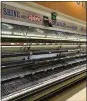  ?? RICHARD VOGEL — THE ASSOCIATED PRESS ?? An entire section of meat and poultry is left empty at a local grocery store in Burbank, California.