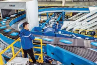  ?? ?? Huaxin Town has brought together over 300 express delivery and logistics enterprise­s over the last decade.