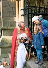  ??  ?? Canon Bashforth says his farewells to members of the congregati­on; both animal and human.