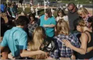  ?? AP PHOTO/JOHN LOCHER ?? People pray at a makeshift memorial for victims of the Oct. 1 2017, mass shooting in Las Vegas.