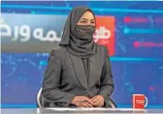  ?? (AFP) ?? A female presenter for Tolo News, Sonia Niazi, covers her face in a live broadcast at Tolo TV station in Kabul on Sunday