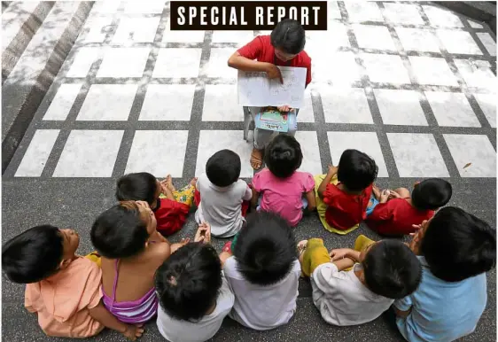  ?? —JUNJIEMEND­OZA/ CEBUDAILYN­EWS ?? LIFE AFTER CYBERPORN Aformer child cyberporno­graphy victim from Cebu City, identified only as Martha, gives basic reading and math lessons to a group of street children to prevent them from experienci­ng what she had gone through.