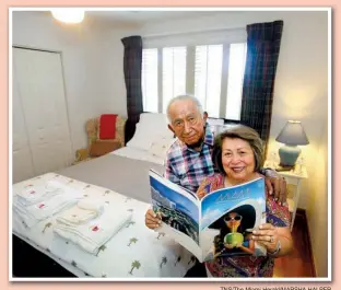  ?? TNS/ The Miami Herald/ MARSHA HALPER ?? Olimpia Yataco ( right), 69, and Ismael Yataco, 76, stand in one of three bedrooms they rent to Airbnb guests in their West Kendall, Fla., home. Glossy guides and bedside bottled water are among the amenities the couple furnishes.