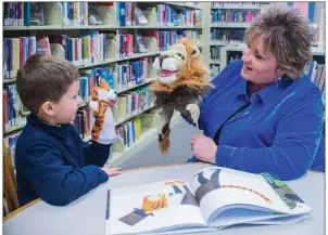  ?? WILLIAM HARVEY/RIVER VALLEY & OZARK EDITION ?? Beckett Pelto, 6, talks with Kim Tyler at the Faulkner County Library’s Greenbrier branch. Tyler, who reads to children at the library every Wednesday, was named Citizen of the Year by the Greenbrier Area Chamber of Commerce.