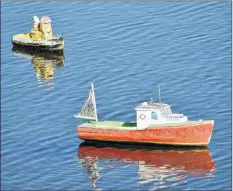  ?? KATHY JOHNSON ?? Theodore Tugboat floats near the Little Cape Islander in Floyd Stewart’s flotilla of more than 30 miniature vessels.