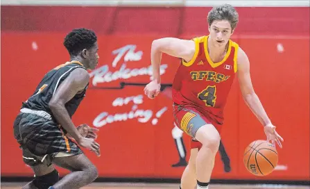  ?? JULIE JOCSAK THE ST. CATHARINES STANDARD ?? Greater Fort Erie’s Austin Ladouceur drives the ball past Ridley’s Sisan Tuedor in qualifying-round action at the Standard High School Boys Basketball Tournament Monday in St.Catharines.