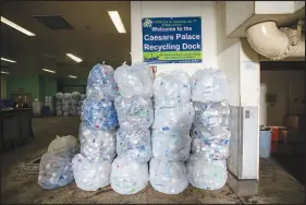  ?? ?? Bags of plastic bottles are stacked against a wall in the Caesars Palace recycling dock.