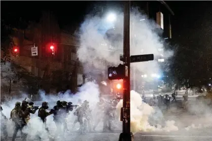  ?? Photograph: Noah Berger/AP ?? Federal agents use crowd control munitions to disperse Black Lives Matter protesters in Portland, Oregon, on 20 July 2020.