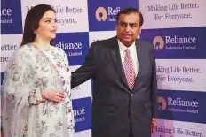  ?? AP ?? Mukesh Ambani with his wife Nita arrives for the company’s annual general meeting in Mumbai.