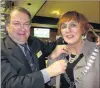  ?? PHOTO: PHILIP CHANDLER ?? Chain of command . . . Outgoing Queenstown Rotary president Keith McIntosh hands the chains of office to Monica Mulholland.