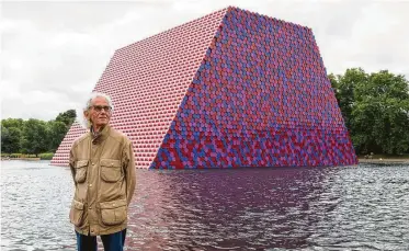  ?? Dominic Lipinski / Associated Press ?? Artist Christo unveils his first U.K. outdoor exhibit, “The London Mastaba,” on the Serpentine Lake in London’s Hyde Park. The sculpture consists of 7,506 horizontal­ly stacked barrels on a floating platform.