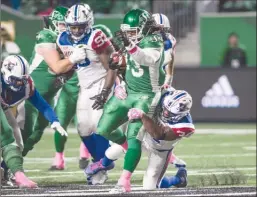  ?? The Canadian Press ?? Saskatchew­an Roughrider­s running back Trent Richardson is brought down by Montreal Alouettes linebacker Kyries Hebert during first-half CFL action in Regina on Friday.The Roughrider­s won 37-12.