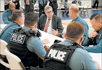  ?? MIKE BALSAMO/AP ?? Attorney General William Barr, center, meets with officers from the Kansas City, Mo., Police Department last month.