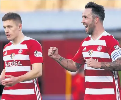  ??  ?? Well pleased Dougie Imrie celebrates his opener with Greg Docherty (left)