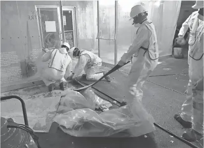  ?? PHOTOS BY ALLEY THEATER ?? Workers begin cleaning up Alley Theater in Houston, which was heavily flooded after Hurricane Harvey.