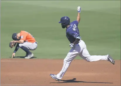  ?? GREGORY BULL — THE ASSOCIATED PRESS ?? The Tampa Bay Rays’ Manuel Margot rounds the bases past the Houston Astros’ Jose Altuve after hitting a three-run home run against starting pitcher Lance McCullers Jr. during the first inning in Game 2of the American League Championsh­ip Series on Monday in San Diego.