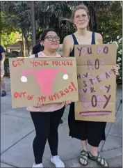  ?? ?? Jaquelin Hernandez, left, and Kira Willman hold signs at a rally and march held at the Chico City Plaza on Tuesday in Chico.