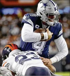  ?? JONATHAN DANIEL / GETTY IMAGES ?? Cowboys quarterbac­k Dak Prescot is tackled by Bears cornerback Kyle Fuller during Chicago’s 31-24 win Thursday.